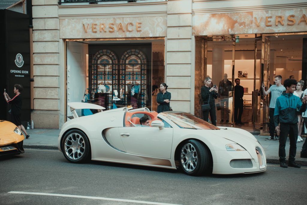 supercar white Bugatti Veyron parked in front of building
